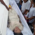 Funeral of Indonesian woman with open casket