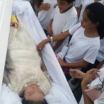 Funeral of Indonesian woman with open casket