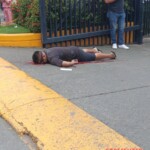 Man talking on phone surprised by hitman