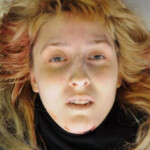 Dead young woman found in parking lot of furniture store