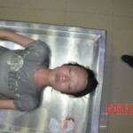 Drowned young Chinese woman pulled from river