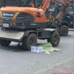 Pedestrian run over by excavator in the middle of intersection