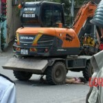 Pedestrian run over by excavator in the middle of intersection