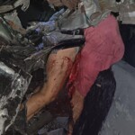 Venezuelan woman hanging out of crashed pick-up