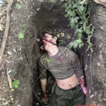 Burying two fallen Russian soldiers in shallow grave
